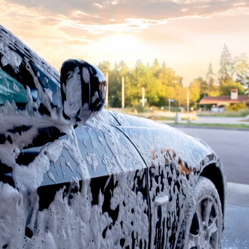 Car wash. Close-up car is in the active foam.